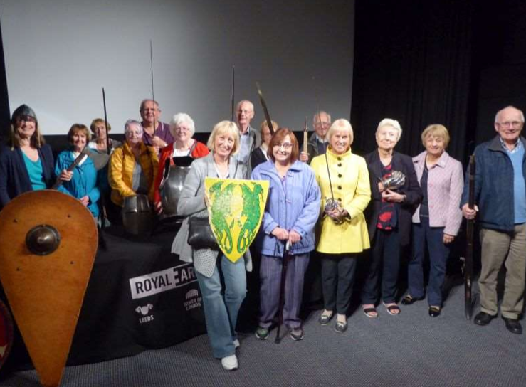 The History Group at Leeds Armouries holding swords and shields