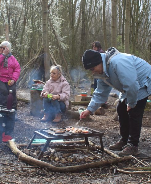 A group learning Bushcraft around a campfire